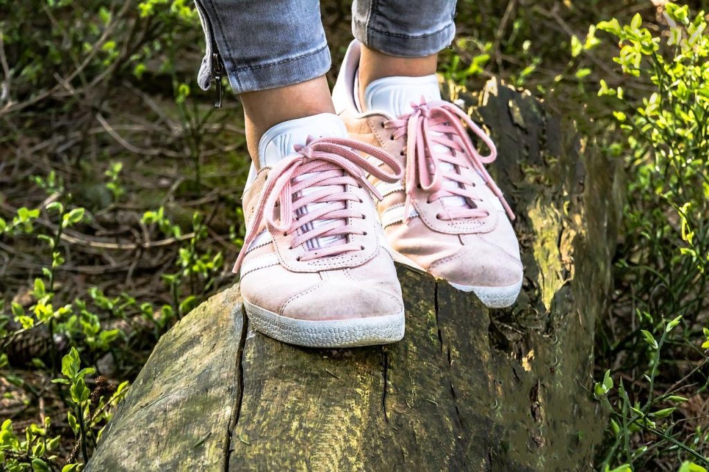 Vrouw test pasvorm van wandelschoenen voor dames in outdoorwinkel voor optimaal comfort